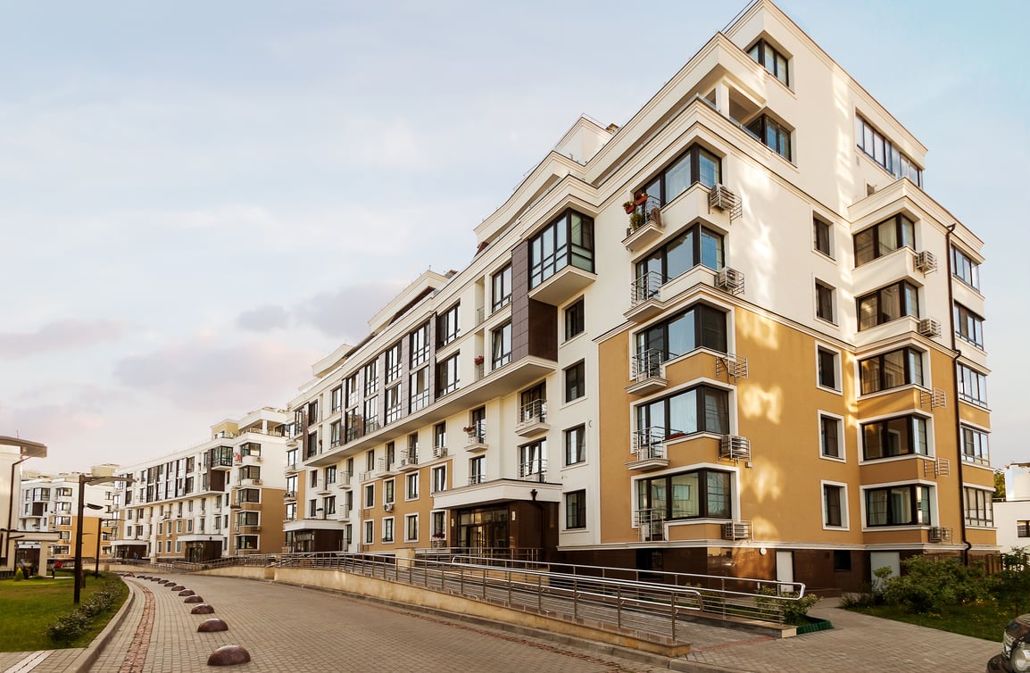 Low-rise houses mixed-use urban multi-family residential district area development blue sunny sky background